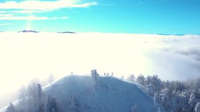 Winter Mountain Ridge Emerging From Fog With Hikers on the Summit - Powered by Shutterstock - Get 15% off with code: PIKWIZARD15