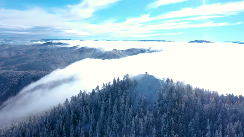 Epic Winter Landscape: Mountain Summit Above Thick Fog Layers