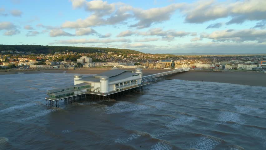 Wide aerial shot of the Grand Pier at Weston Super Mare in the United Kingdom on sunny day. High quality 4k footage