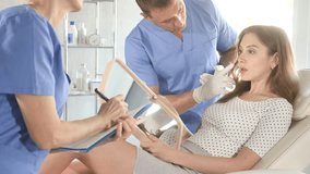  Doctor consulting woman in clinic. Patient having medical exam with doctor on illness and discomfort. - Powered by Shutterstock - Get 15% off with code: PIKWIZARD15