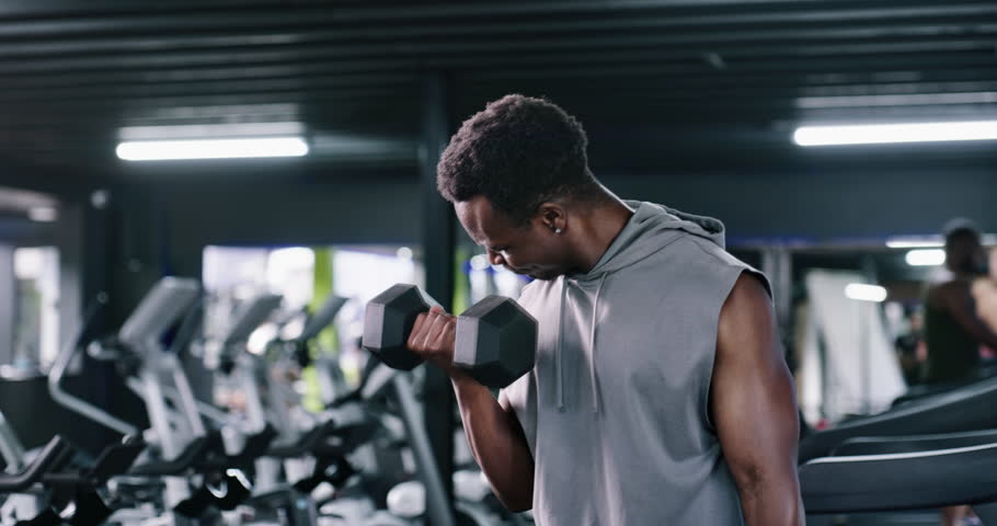 Breathing, dumbbell and fitness with man in gym for strength training or workout routine. Exercise, intensity and weightlifting with bodybuilder in health club for physical challenge or resilience