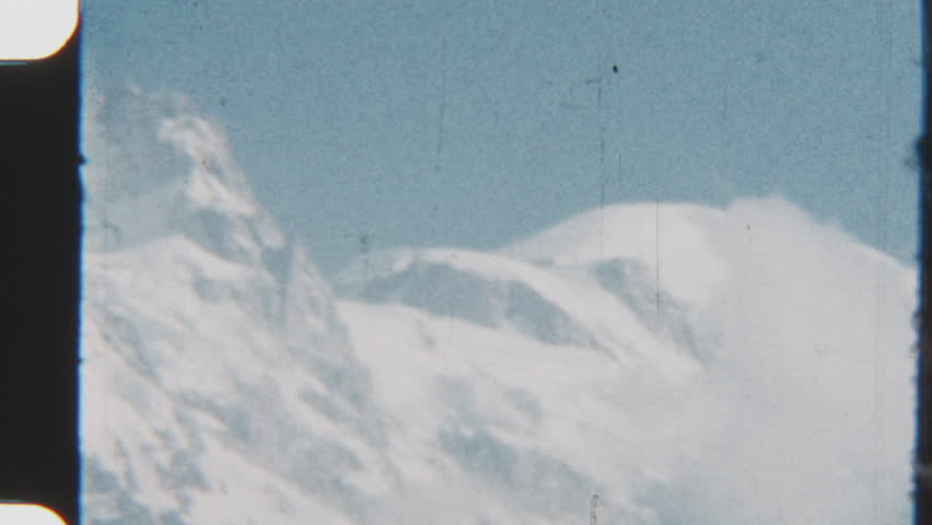 A serene vintage 8mm film captures the majestic Mont Blanc, Europe s highest peak, bathed in soft sunlight