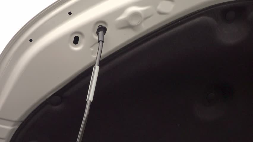 metal fixing rod is inserted to secure the open car hood in place. The definitive sound of the metal latch engaging and locking the hood