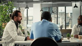 Team of doctors and nurses in meeting discuss treatment strategies and diagnosis plans. Diverse healthcare team collaborates on innovation and patient care solutions. Camera B. - Powered by Shutterstock - Get 15% off with code: PIKWIZARD15