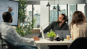 Diverse business colleagues gathered around laptops working on project tasks for development. Office environment promotes synergy, teamwork and insight through analytics. Camera B. - Powered by Shutterstock - Get 15% off with code: PIKWIZARD15