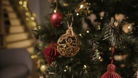 A detailed 4K view of a Christmas tree with traditional ornaments, including a gold filigree ball, red paper honeycomb, and a miniature candy cane. - Powered by Shutterstock - Get 15% off with code: PIKWIZARD15