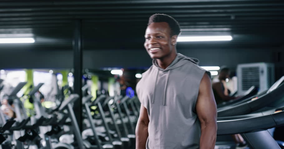 Fitness, weightlifting or athlete in gym with dumbbell, training or bicep curl in bodybuilding. Happy, exercise or man in club with equipment, intense workout or strength in muscle transformation.