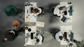 Top down view zoom in of professional employees working together in office. Diverse work team collaborates on project planning, analytics and report writing for corporate development. Camera A. - Powered by Shutterstock - Get 15% off with code: PIKWIZARD15