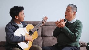 Son plays guitar as father sings along happily on cozy sofa setting - Powered by Shutterstock - Get 15% off with code: PIKWIZARD15