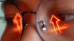 A person wearing glasses works on a laptop, with a glowing digital upward arrow reflected in the lens. The image conveys startup growth, progress, innovation, business success, and rising performance. - Powered by Shutterstock - Get 15% off with code: PIKWIZARD15