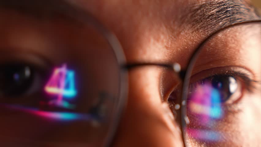 A person wearing glasses works on a laptop, with a glowing digital justice scale reflected in the lens. The image conveys themes of law, ethics, fairness, digital governance, modern legal technology.