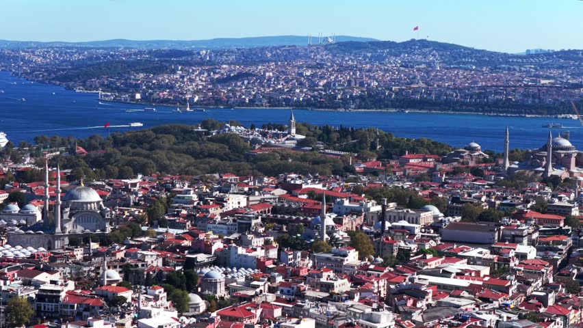 Morning Istanbul Turkey Türkiye aerial drone the Golden Horn Blue Mosque temple Hagia Sophia Grand Mosque cityscape Bosphorus Strait river ferries boats harbor view blue sky backwards motion