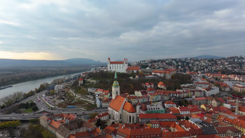 4K Aerial view of Bratislava Castle in Slovakia, capturing the grand courtyards, fortified walls, and panoramic cityscape stretching across the old town and modern districts. Slovakia_02