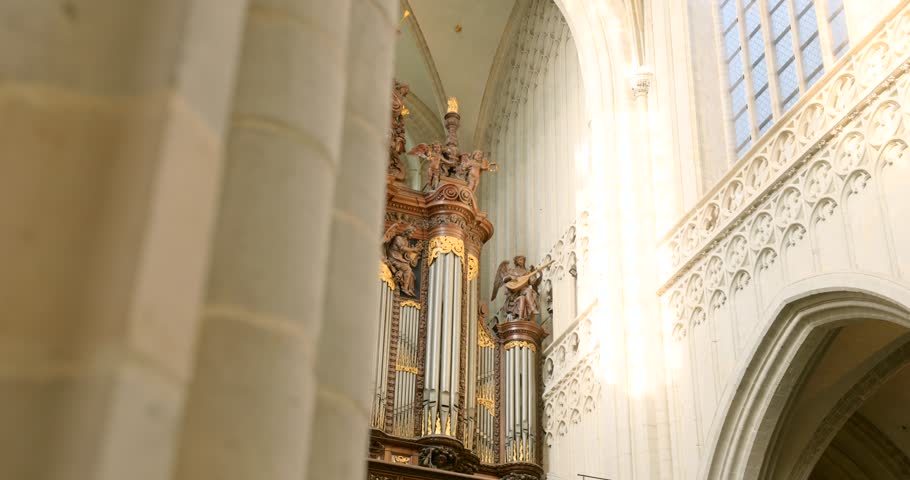 Ornate pipe organ standing inside the historic Cathedral of Our Lady playing music