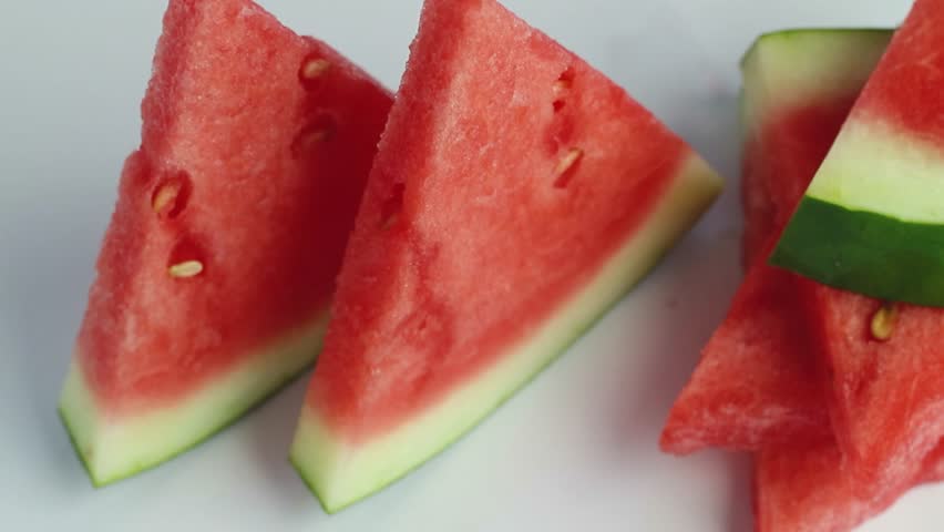 Red seedless watermelon slices isolated on white background with full depth of field.