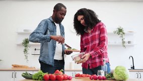 A couple prepares a healthy meal together in a bright, modern kitchen, chopping vegetables and enjoying each other's company. - Powered by Shutterstock - Get 15% off with code: PIKWIZARD15