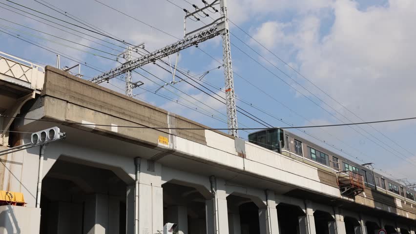 A train on the Hokushin Line passes by in Kobe. 