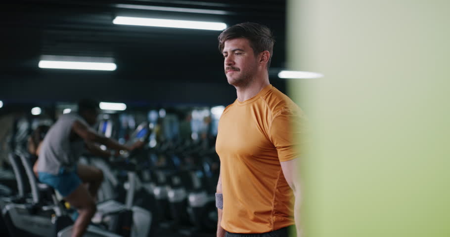 Breathing, dumbbell and exercise with man in gym for strength training or workout routine. Fitness, intensity and weightlifting with bodybuilder in health club for physical challenge or resilience
