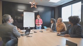 Diverse colleagues applaud a businesswoman after her presentation in a modern office meeting room - Powered by Shutterstock - Get 15% off with code: PIKWIZARD15