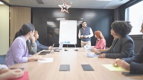 Business team applauding male speaker after successful presentation in modern office meeting room - Powered by Shutterstock - Get 15% off with code: PIKWIZARD15