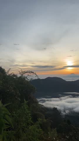 Beautiful sunrise over mountain peaks with clouds below, perfect nature landscape for travel and photography lovers.