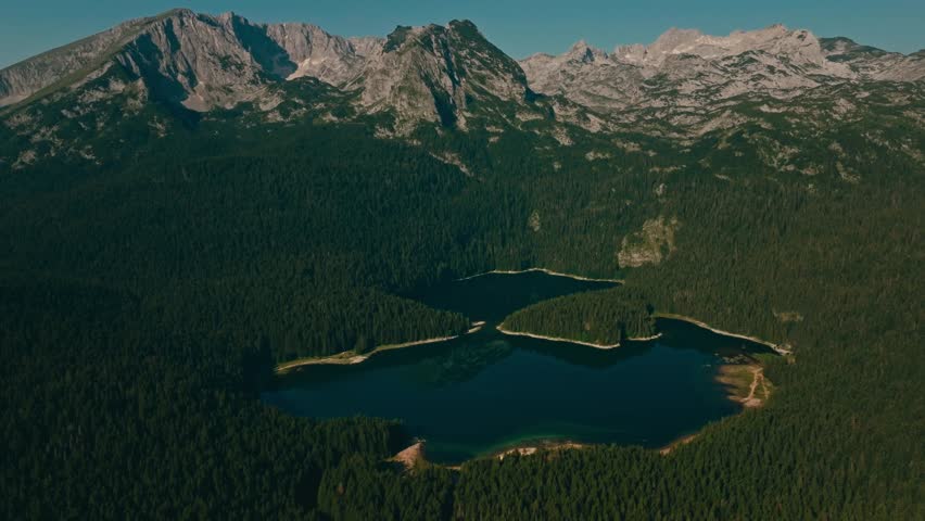 Serene Black Lake at sunrise in Durmitor National Park, Montenegro