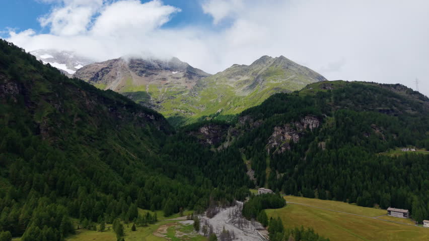 Switzerland Mountains Drone View: Lush Forest and Snow Peaks