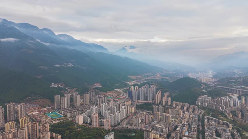 Pan down drone shot Wuxi’s modern skyline with dense high rises and cityscape. China