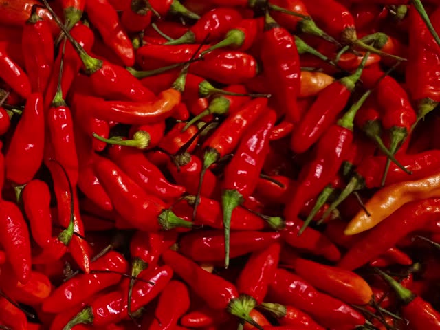 Capturing a close-up view of fresh red chilies stacked up.