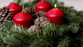 Close up of an advent wreath with one red burning candle on white table  - Powered by Shutterstock - Get 15% off with code: PIKWIZARD15