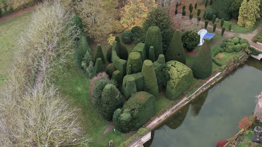 Large Topiary Hedges At The Gardens Of Kentwell Hall, Stately Home In Suffolk, England. Aerial Shot