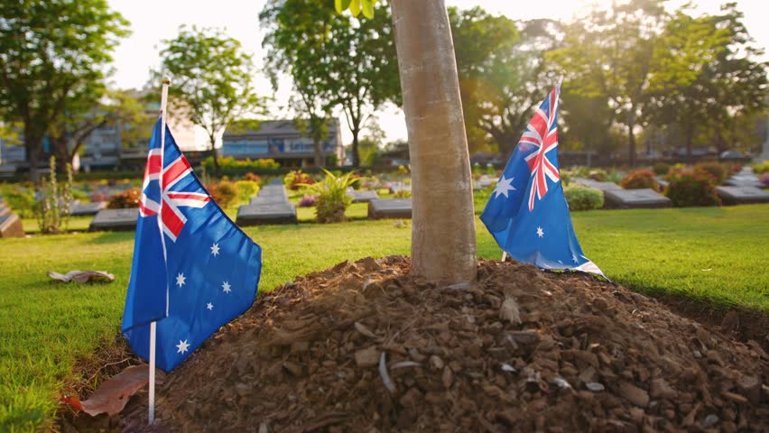 Australian flag waving in a military cemetery, Kanchanaburi, Thailand. Anzac Day