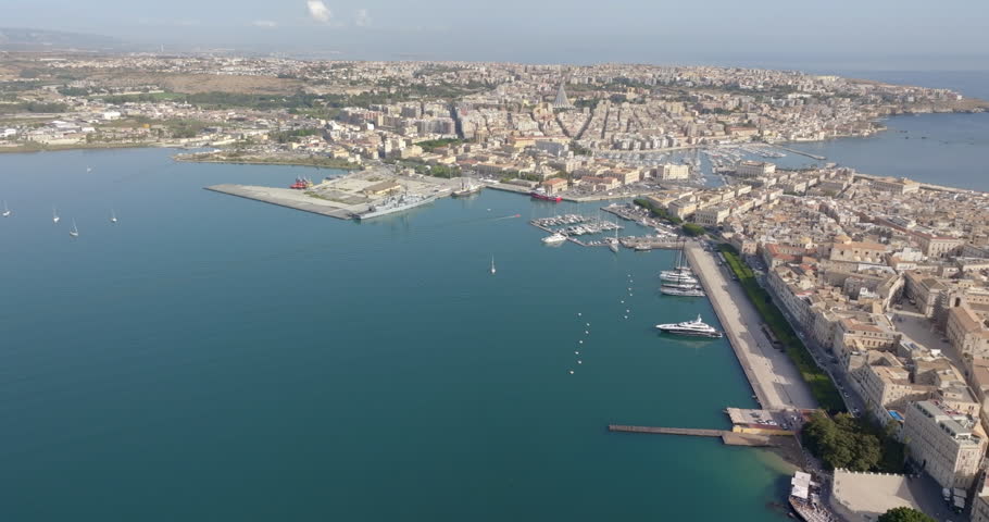 Aerial view of the Gulf of Syracuse, Sicily, southern Italy. It is a large bay in the Mediterranean Sea, and the city is on the right of the frame. Beautiful summer day.