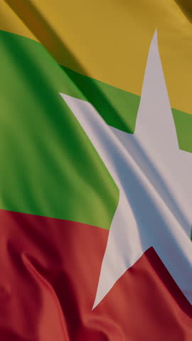Myanmar, Naypyidaw: Cinematic Vertical Waving National Flag Against Blue Sky