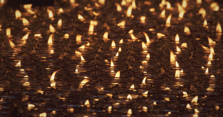 Chengdu, Sichuan, China. Close-up View Of Burning Red Candles In Glass. Concept For Faith, Religion And Spirituality. Religious Ritual In Temple. Many Lit Candles In Buddhist Temple. Many Oil Lamps