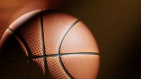 A close-up basketball rotates in a seamless loop, filling the frame with detailed texture and warm reflections from court lights. Atmospheric, smooth, and perfect for sports backgrounds or intros. - Powered by Shutterstock - Get 15% off with code: PIKWIZARD15