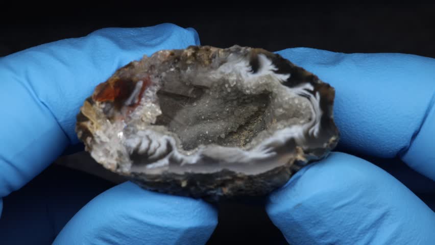 Crystal gland with shiny crystals in hand close up