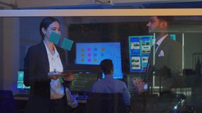 Businessman and businesswoman corporate professional brainstorming , discussing ideas, innovation technology, and writing on glass board in modern office - Powered by Shutterstock - Get 15% off with code: PIKWIZARD15