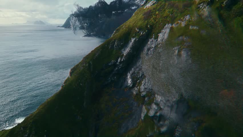 Breathtaking Landscape Showcasing Rugged Cliffs and Vibrant Greenery Along a Tranquil Coastline