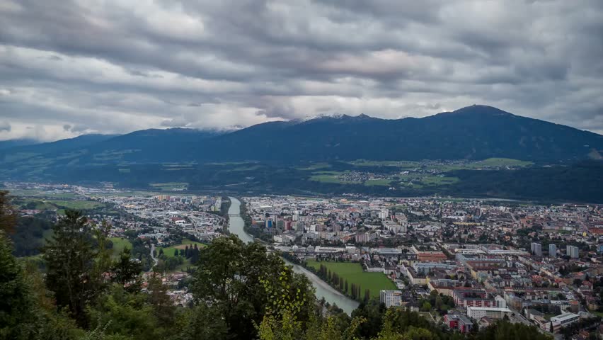 Stunning Aerial View of Innsbruck, Austria Showcasing the Scenic Landscape and Majestic Mountains Under Dramatic Clouds