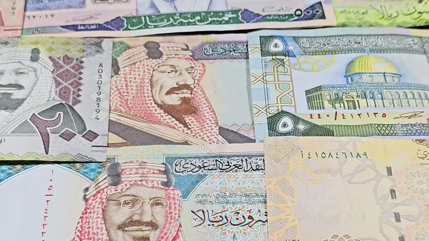 Saudi Arabian riyals SAR banknotes cash money bills, of different times, eras and values, from old vintage retro King Fahd times till king Salman time, Saudi Arabia riyals money and economy concept