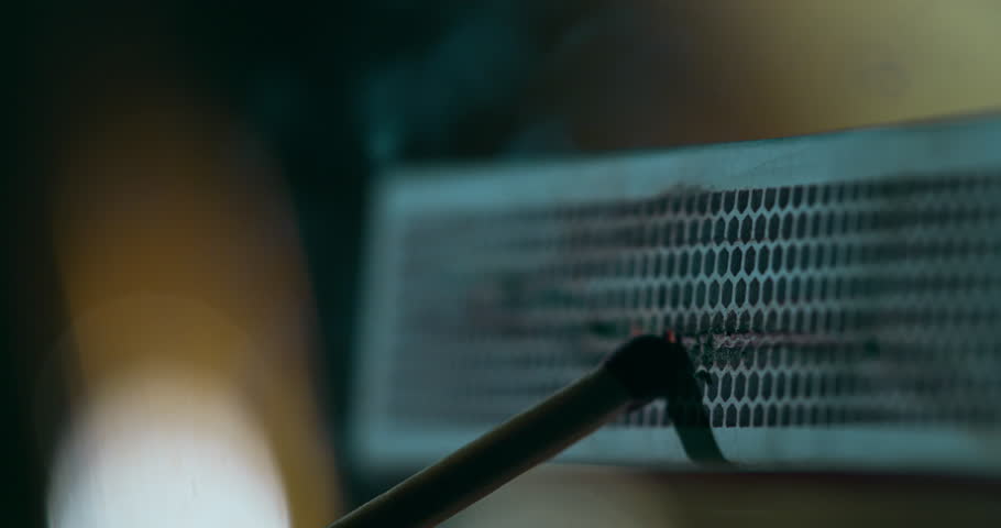 Slow motion close-up of a match being struck on a matchbox and bursting into flame at 1000 fps. Warm tones, detailed sparks, slow-motion ignition.