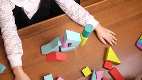 Childs hands aggressively smashing soft foam block tower on table, bright pieces flying apart, emotional release during playtime, useful for psychology blogs, parenting topics and kids therapy content - Powered by Shutterstock - Get 15% off with code: PIKWIZARD15