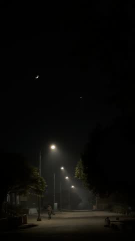a beautiful view of a street with moon shining on top 