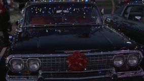 This video video shows a classic, vintage Chevy car decorated with Christmas holiday lights and a gift wrapping bow. - Powered by Shutterstock - Get 15% off with code: PIKWIZARD15