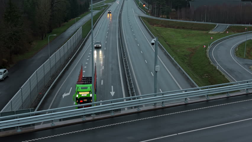 Nighttime highway scene, Elevated perspective of rainy highway with glowing lights and lanes