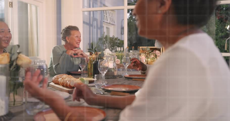 Cam moving closer front woman speaking gesturing while UI icons floating over table showing tech. Dining, gathering, connectivity, warmth, twilight, sunroom, candles