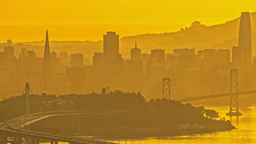 Golden San Francisco skyline at sunset with iconic landmarks in view