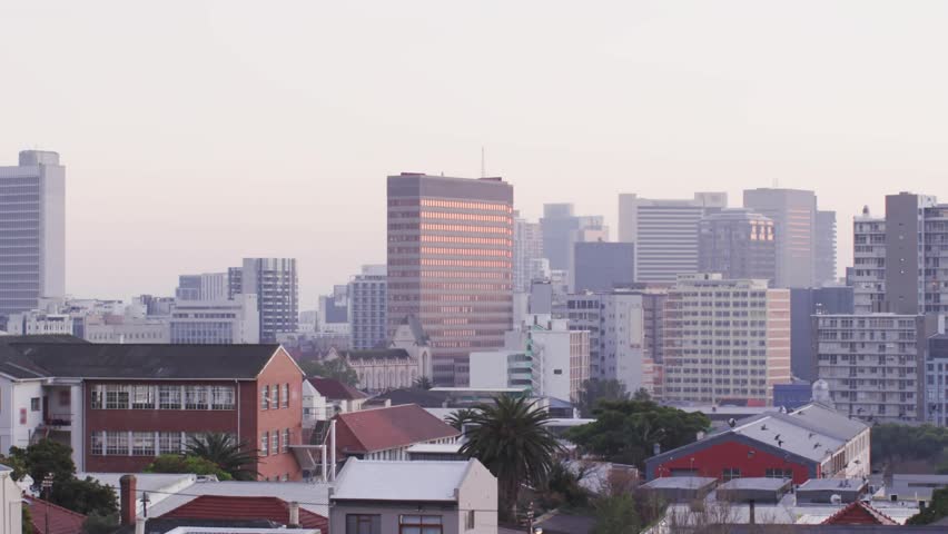 Center urban skyline showing HUD graphics appearing on load rotating filling and showing city data. Panorama, rooftops, palm, midrise, highrise, elevated, overlay