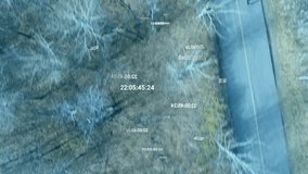 Teen male rider pedaling road entering frame causing globe rising over trees with timecode for tech. Cyclist, drone, aerial, holographic, data, winter, outdoor - Powered by Shutterstock - Get 15% off with code: PIKWIZARD15